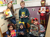 Crew of puppies dressed up with their favourite books