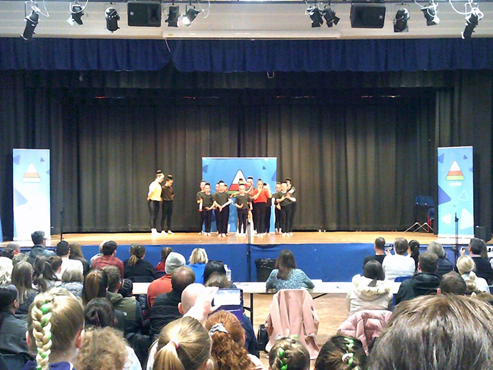 group of people dancing on a stage