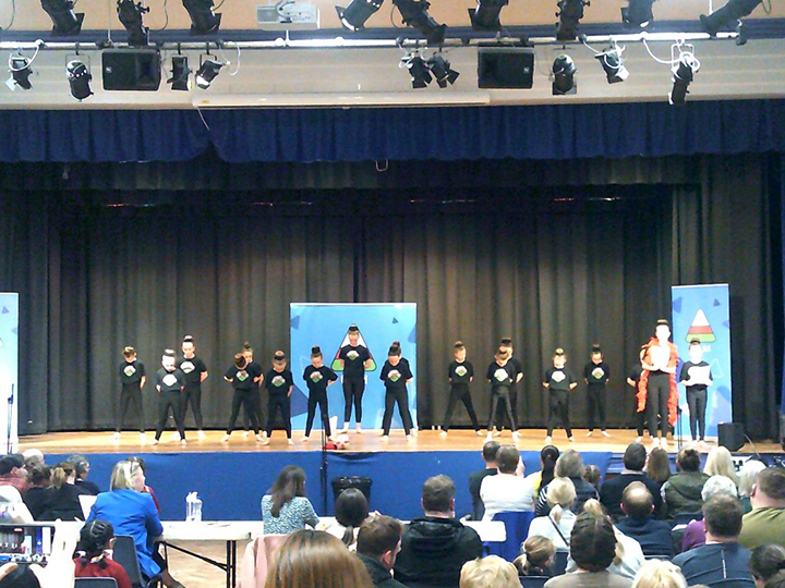 group of people dancing on a stage